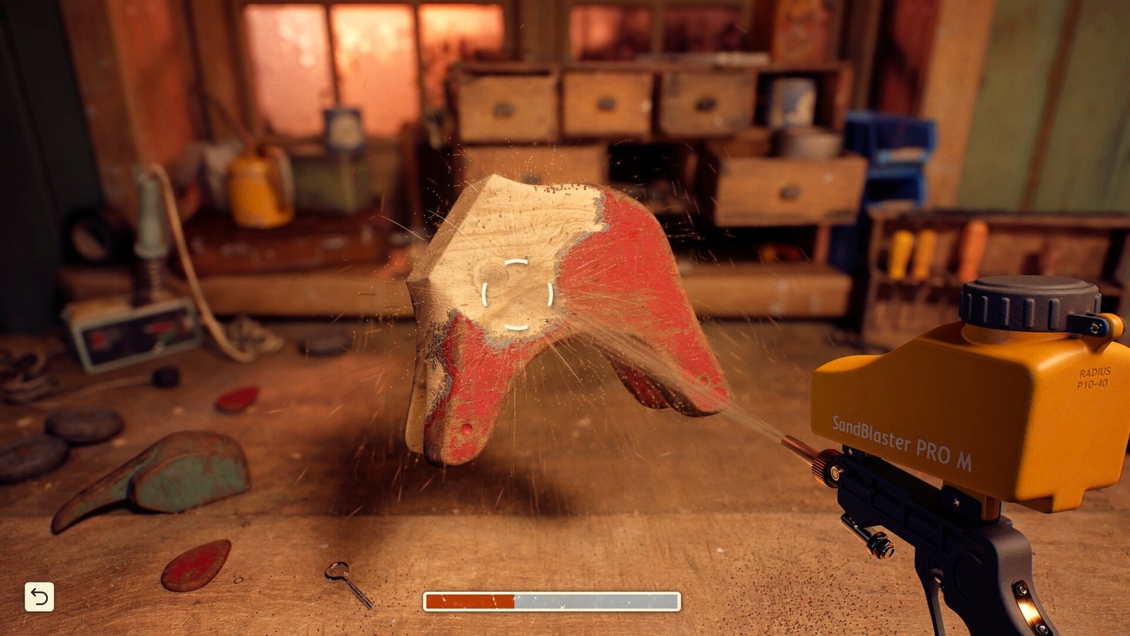 A restoration tool removes a painted layer from an object on the attic workbench.