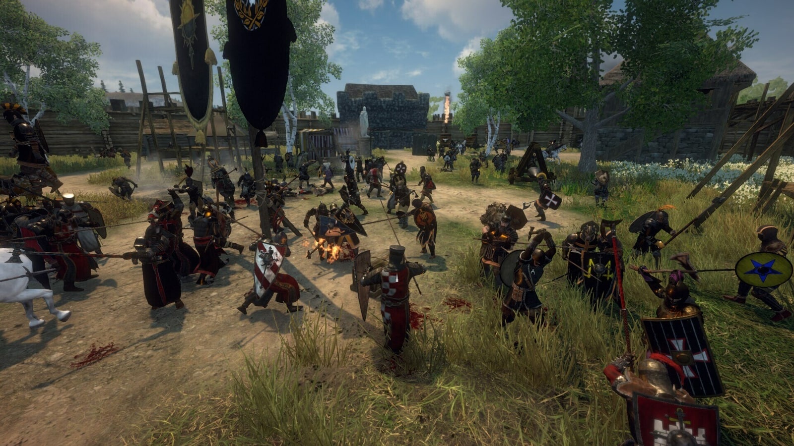 A large group of armoured Gloria Victis players gathers on a grassy road beside banners and buildings.