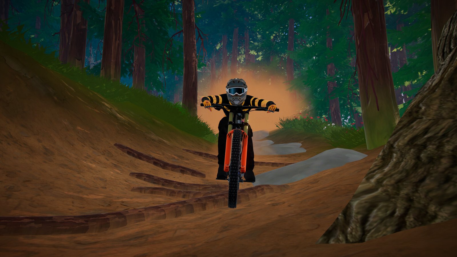 A rider guides a red mountain bike along a forest trail.