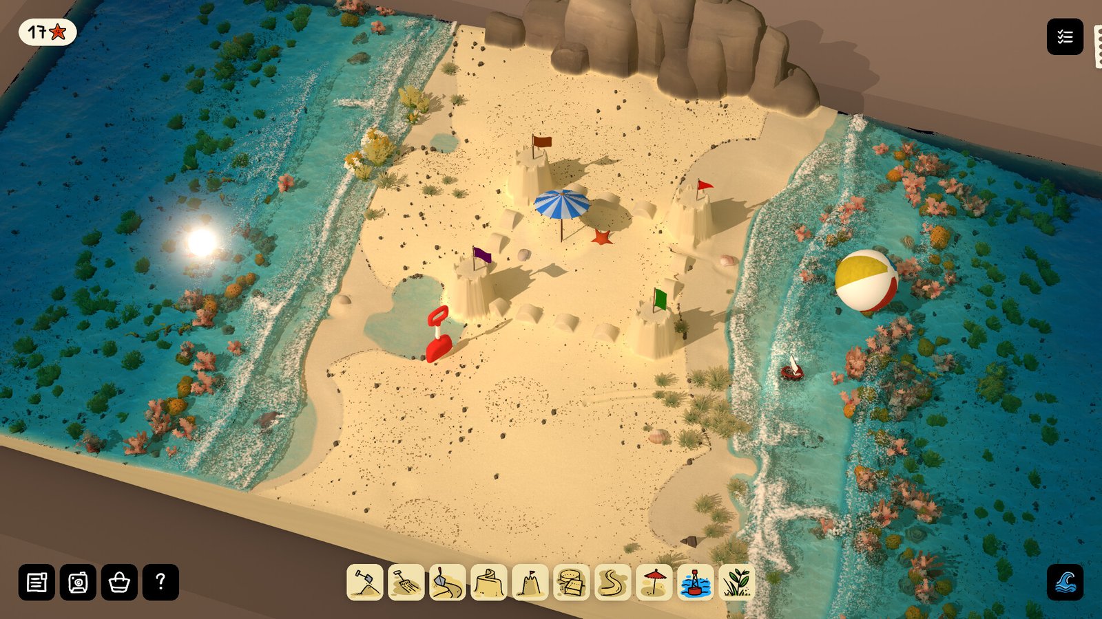 Sandcastles, umbrellas and shaping tools fill a narrow tropical beach.